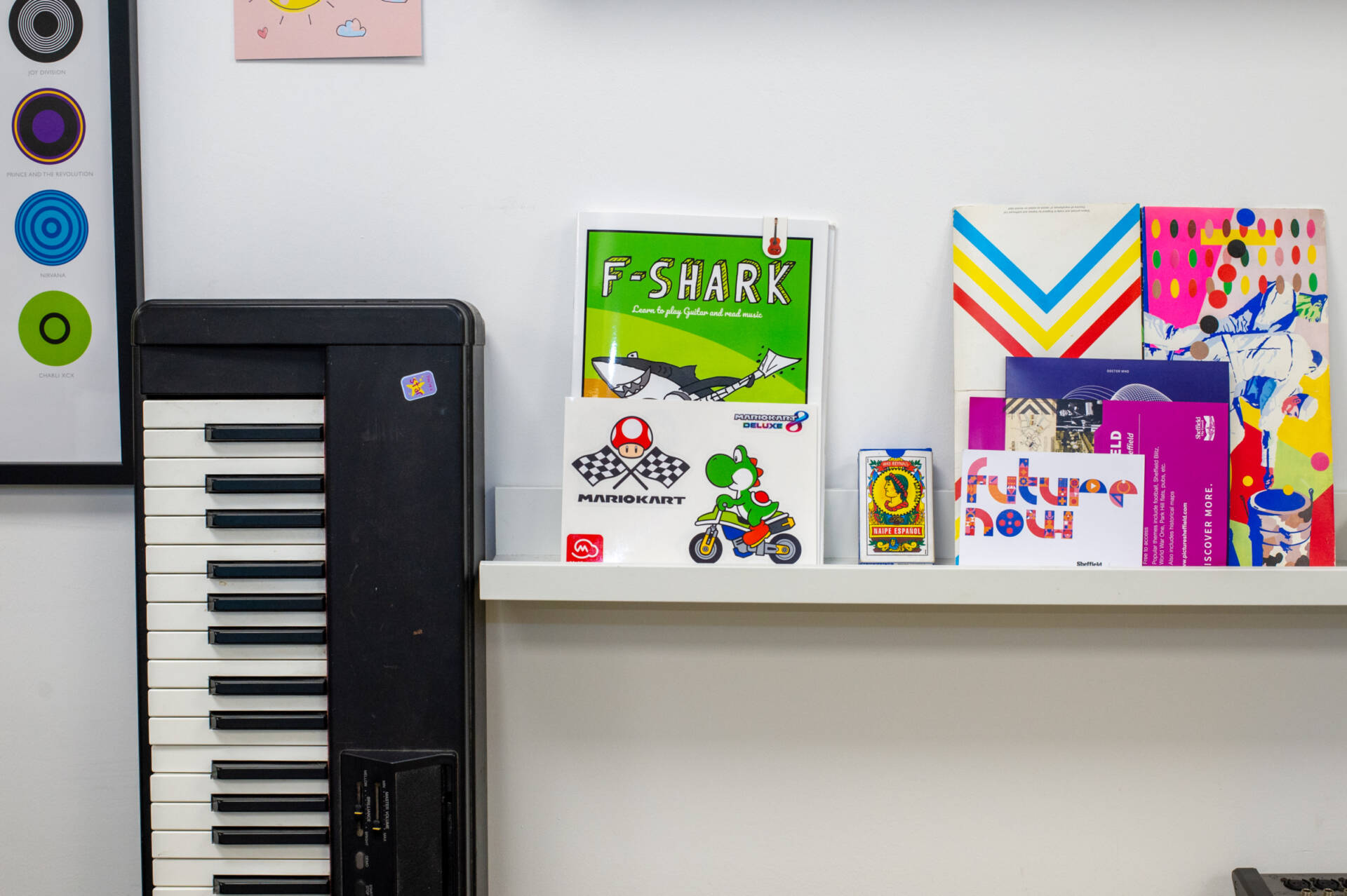 Piano and shelf with music books